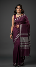 Woman wearing a purple saree with a gray pallu