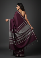 Woman wearing a purple saree with a gray pallu