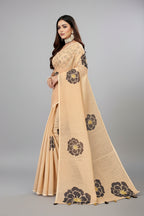 Woman wearing a beige saree with floral patterns